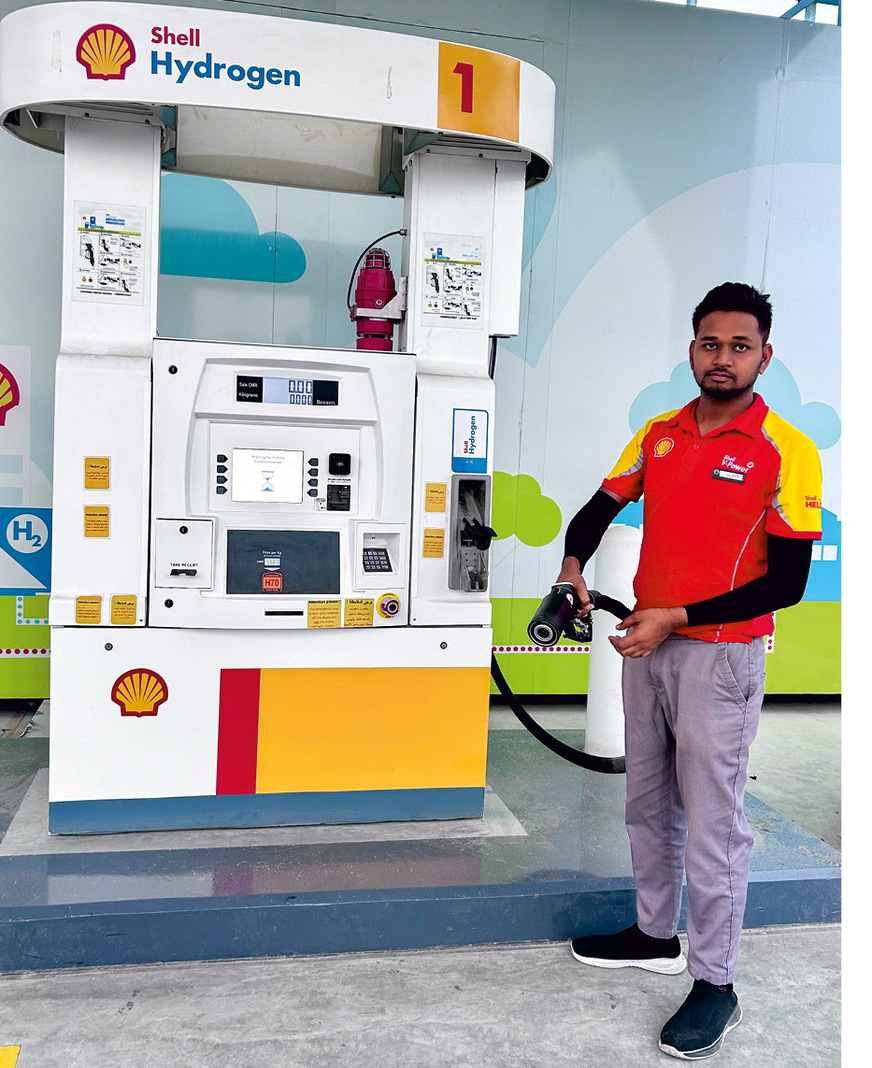 At the new hydrogen filling station in Muscat, Sharik waits for customers with the fuel nozzle.