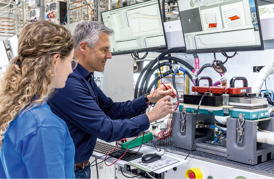 Researcher Alexander Kabza inspects a fuel cell stack.