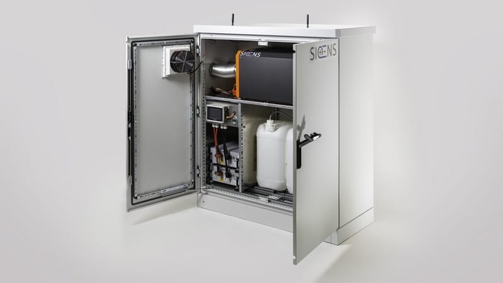 White Siemens industrial cabinet open to reveal electrical and mechanical components inside. White Siemens industrial cabinet open to reveal electrical and mechanical components inside.