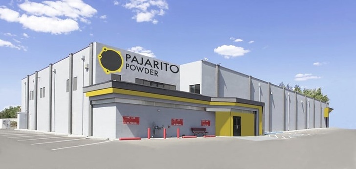 Gray industrial building with "Pajarito Powder" sign, yellow accents, and a mostly empty parking lot. Gray industrial building with "Pajarito Powder" sign, yellow accents, and a mostly empty parking lot.