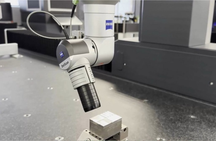 A Zeiss DotScan sensor inspects a small metallic block on a lab workstation.