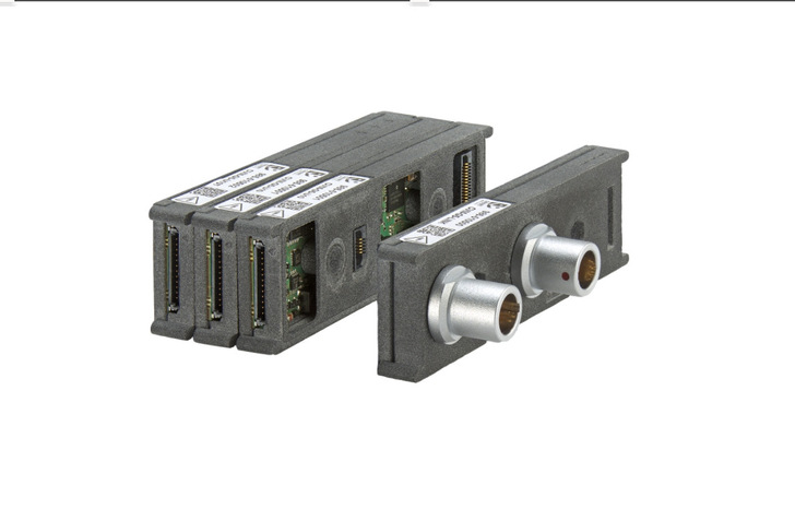Four rectangular electronic modules with metal connectors and ports, shown against a white background. - © Smart Testsolutions