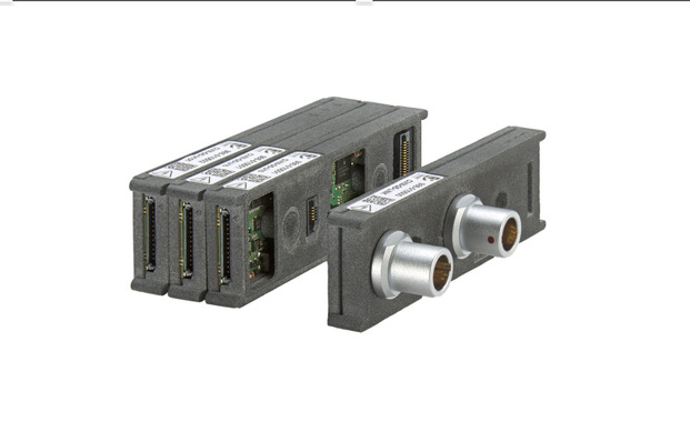 Four rectangular electronic modules with metal connectors and ports, shown against a white background. - © Smart Testsolutions